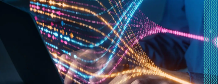 Colorful neon light trails stream from a laptop, conveying fast data transfer and digital networks.