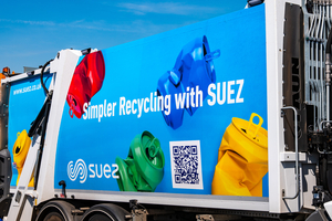 Advertising panel on a recycling truck reading 'Simpler Recycling with SUEZ' with colored recycling bags and a QR code nearby.
