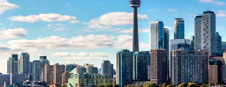 NEW - News item size 84 | Thames Valley Chamber of Commerce Toronto skyline with the CN Tower towering above glass skyscrapers on a sunny day.