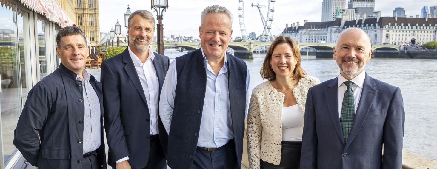 NEW - News item size 35 | Thames Valley Chamber of Commerce Five professionals in business attire posing together on a Thames riverside with the London Eye in the background.