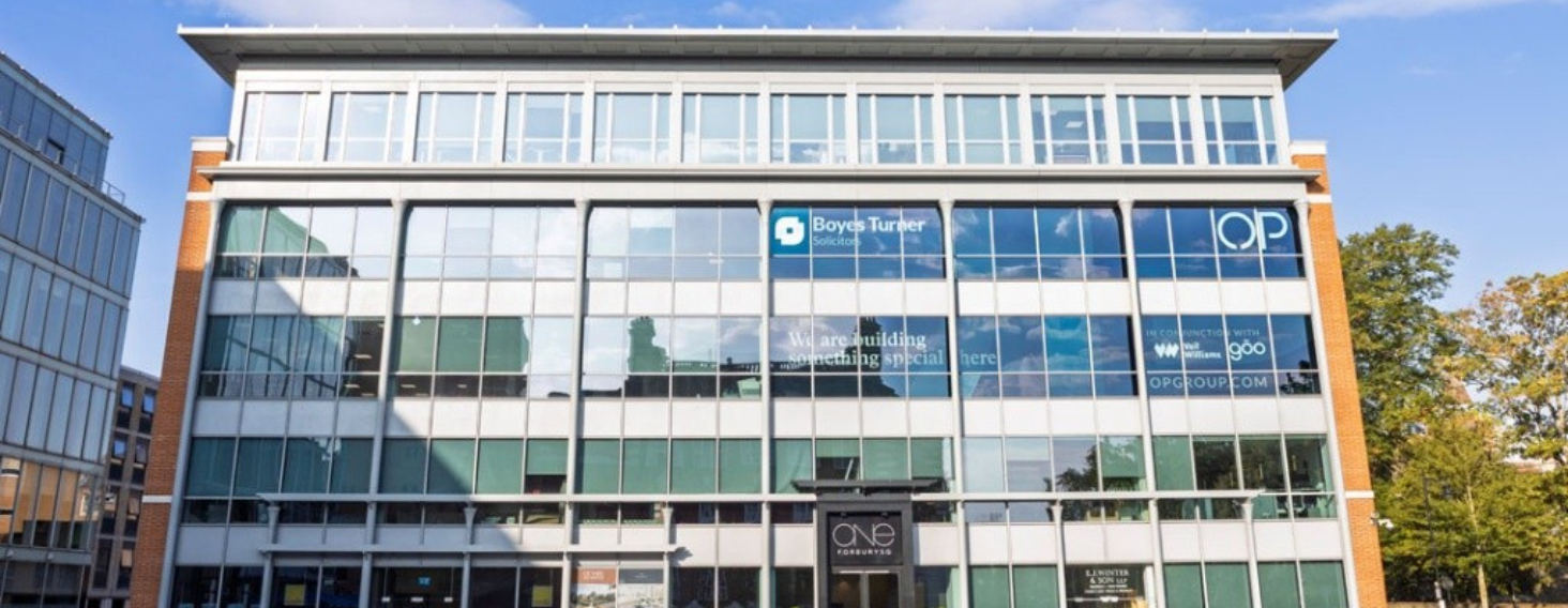 NEW - News item size 83 | Thames Valley Chamber of Commerce Modern glass-front office building with brick columns on the sides; blue Boyes Turner sign on the second floor and large reflecting windows across the façade.