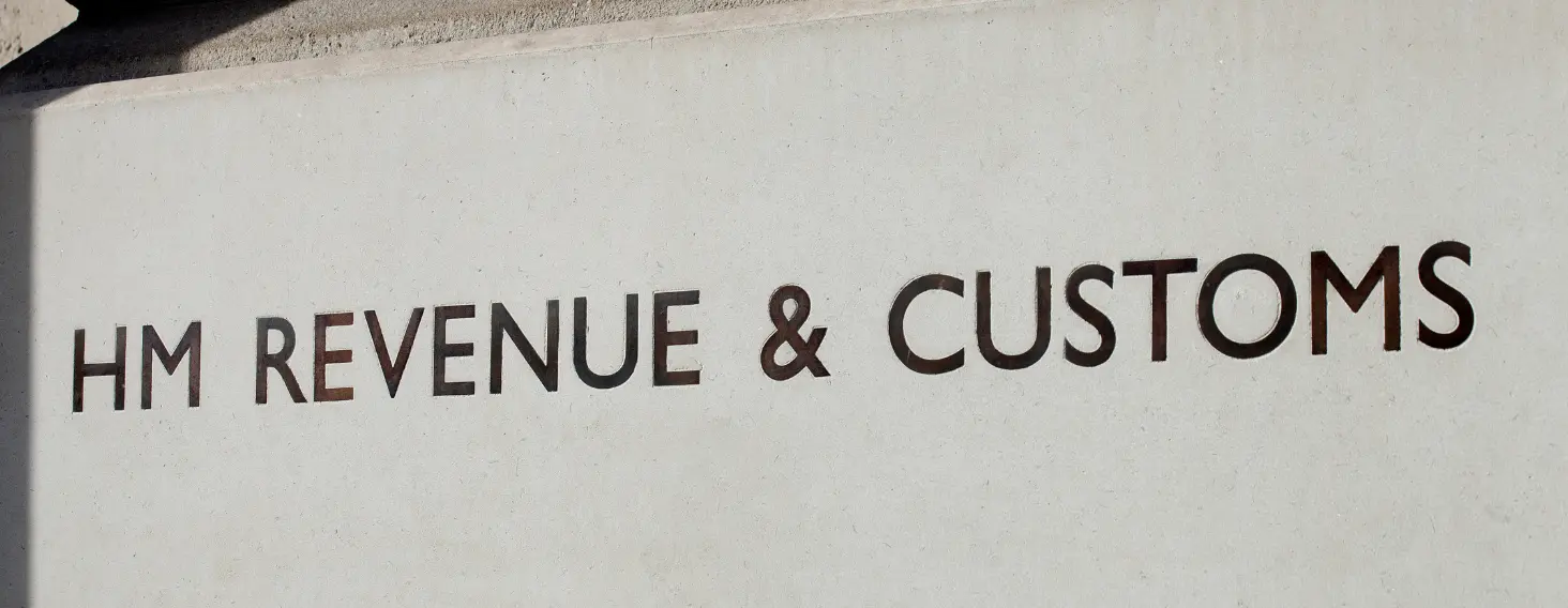 NEW - News item size 87 | Thames Valley Chamber of Commerce Sign reading 'HM Revenue & Customs' on a white concrete wall outside a building, showing the department name clearly