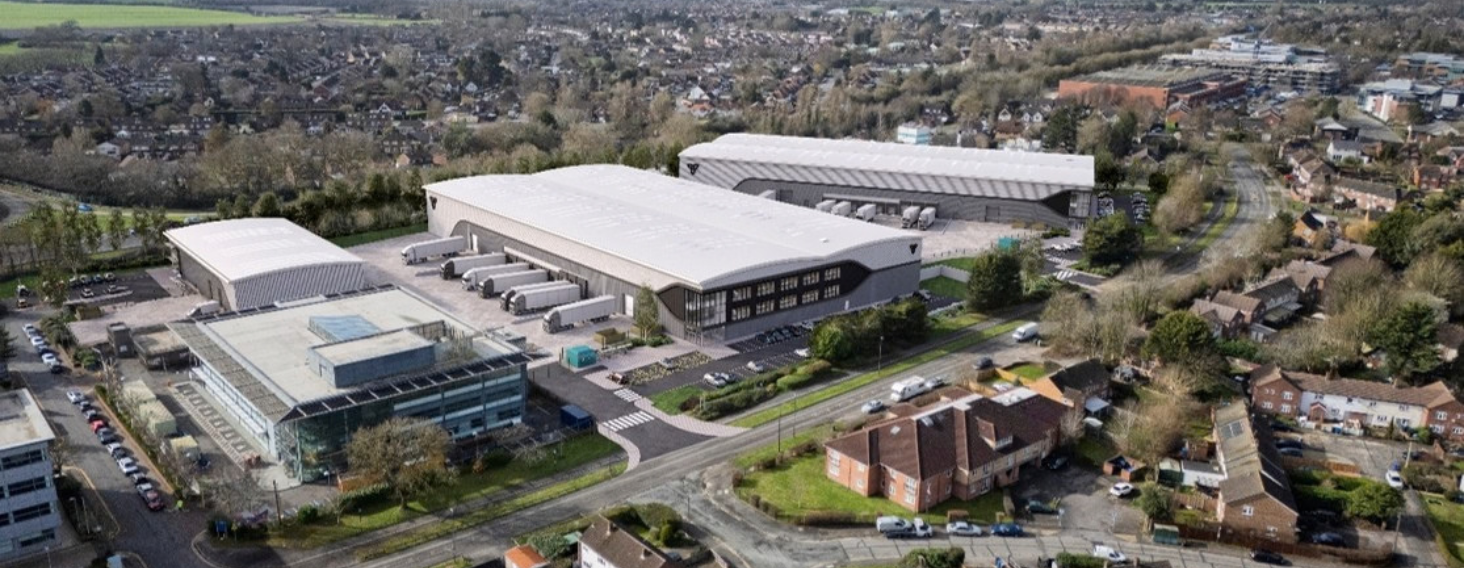 NEW - News item size 90 | Thames Valley Chamber of Commerce Aerial view of a business park with large white-roofed warehouse buildings and surrounding residential streets.