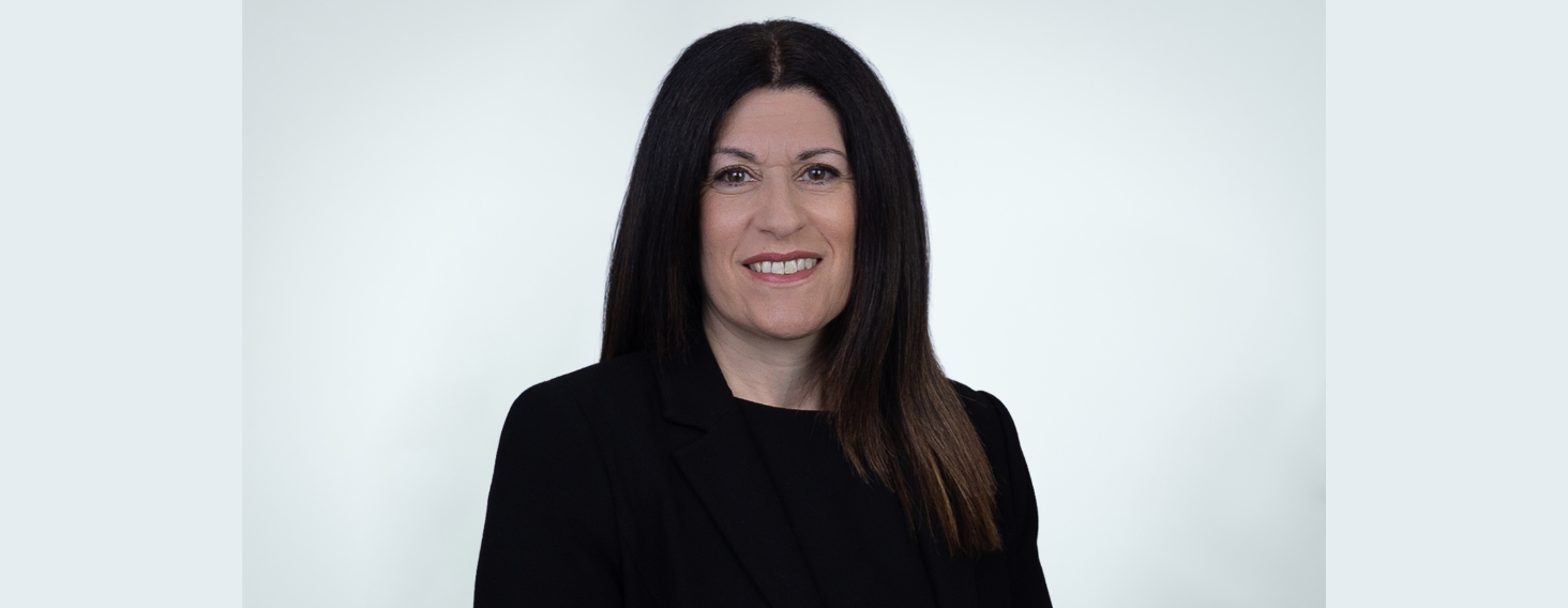 NEW - News item size 93 | Thames Valley Chamber of Commerce Professional headshot of a smiling woman with long dark hair wearing a black blazer against a light gray studio background.